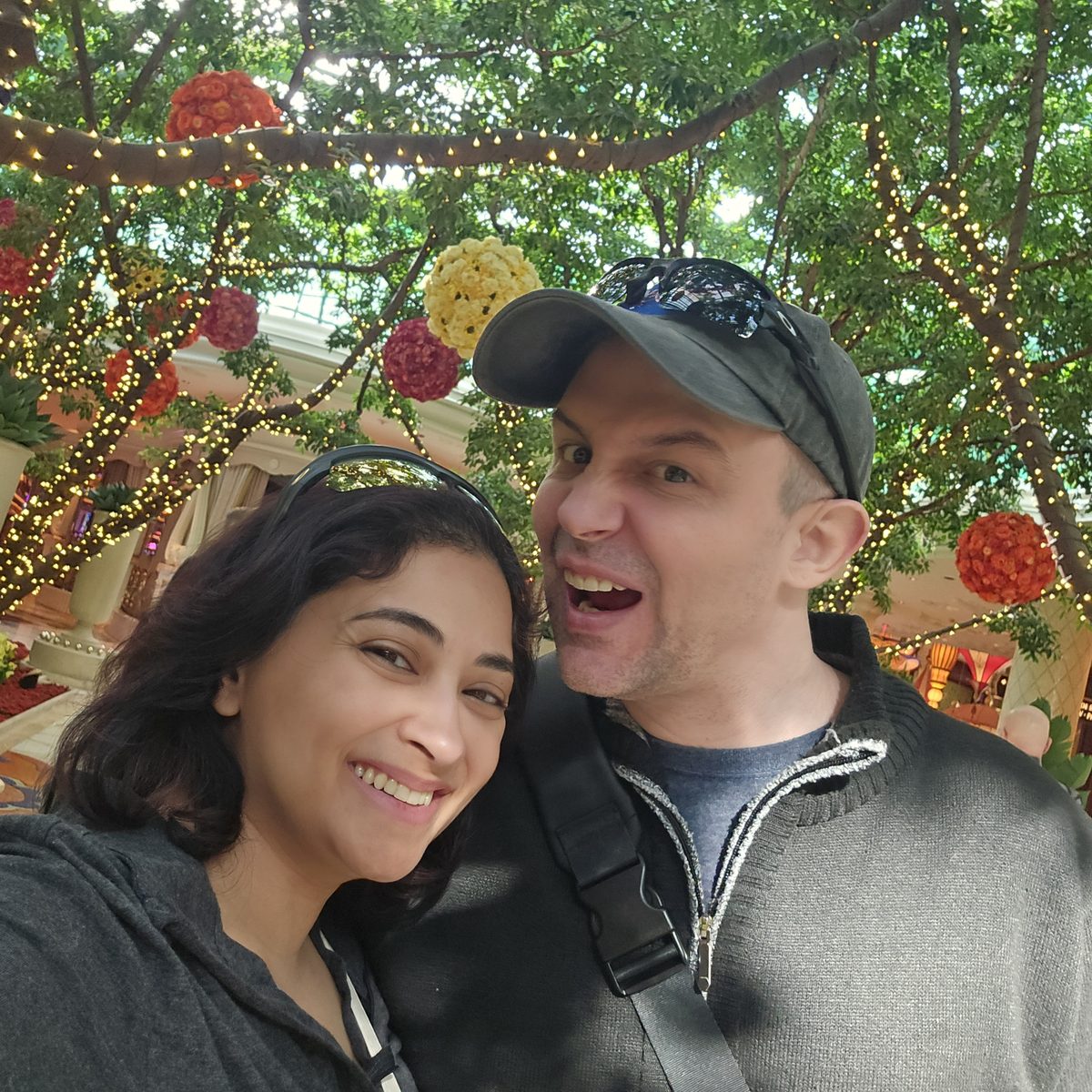 Nick and Nagham under flowers and lights in Las Vegas