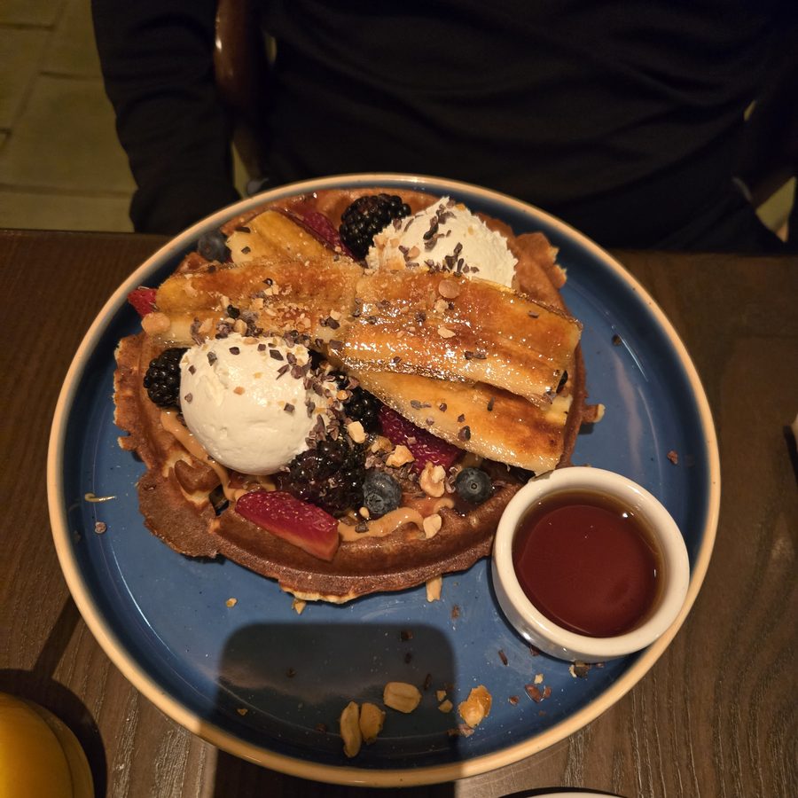 Waffle with berries, ice cream and caramelized banana