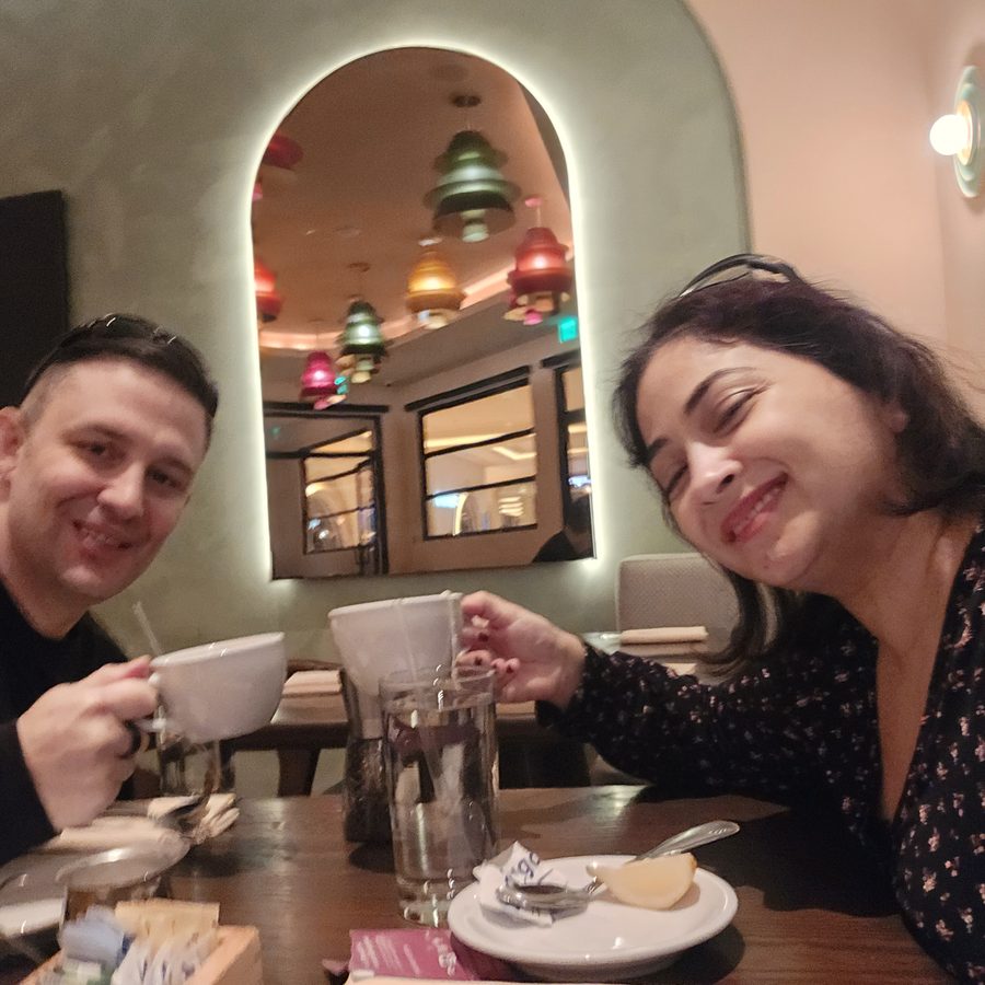 Nick and Nagham clinking coffee cups