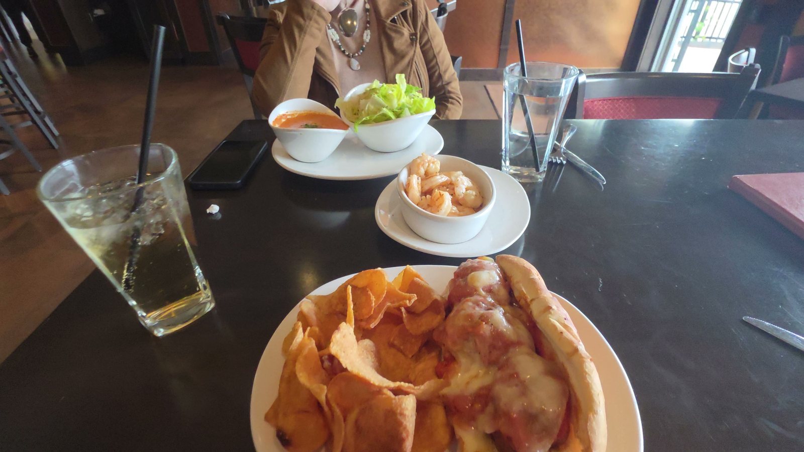 A cup of soup and a side salad