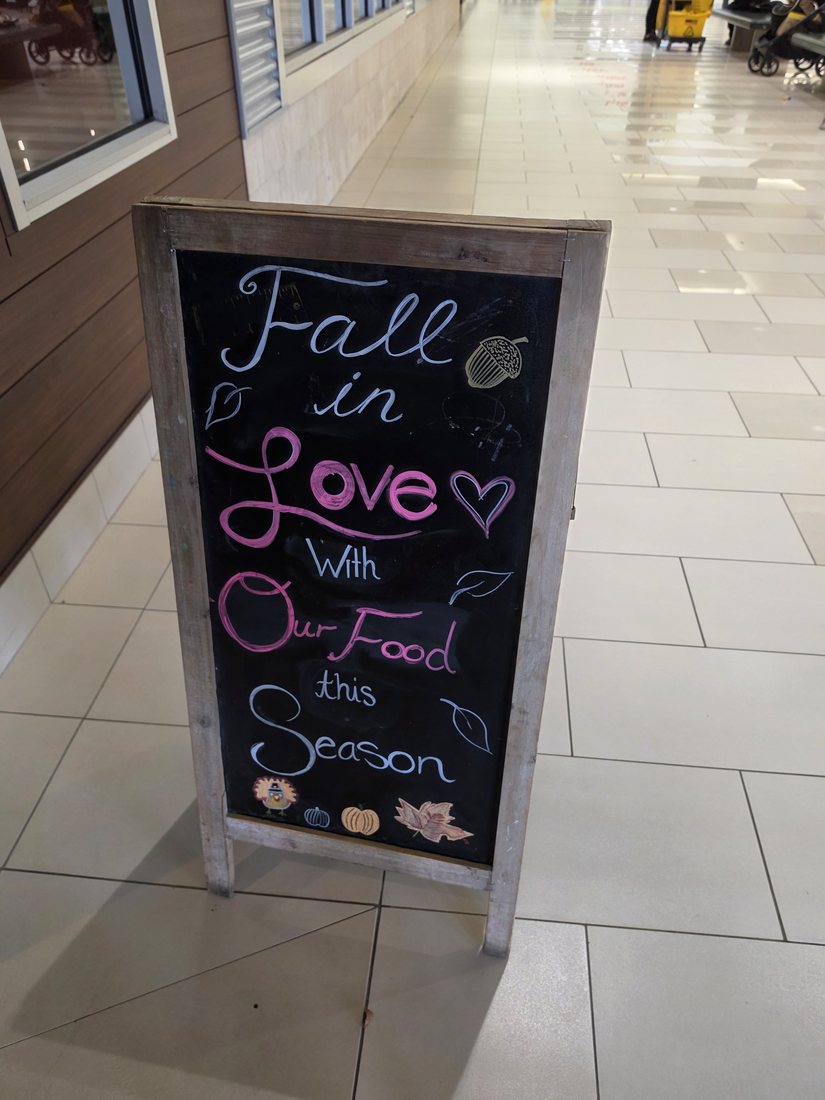 Fall in Love with Our Food chalkboard in the mall hallway