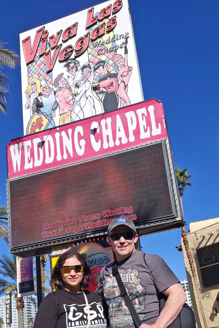 Nick and Nagham under the Viva Las Vegas Wedding Chapel sign