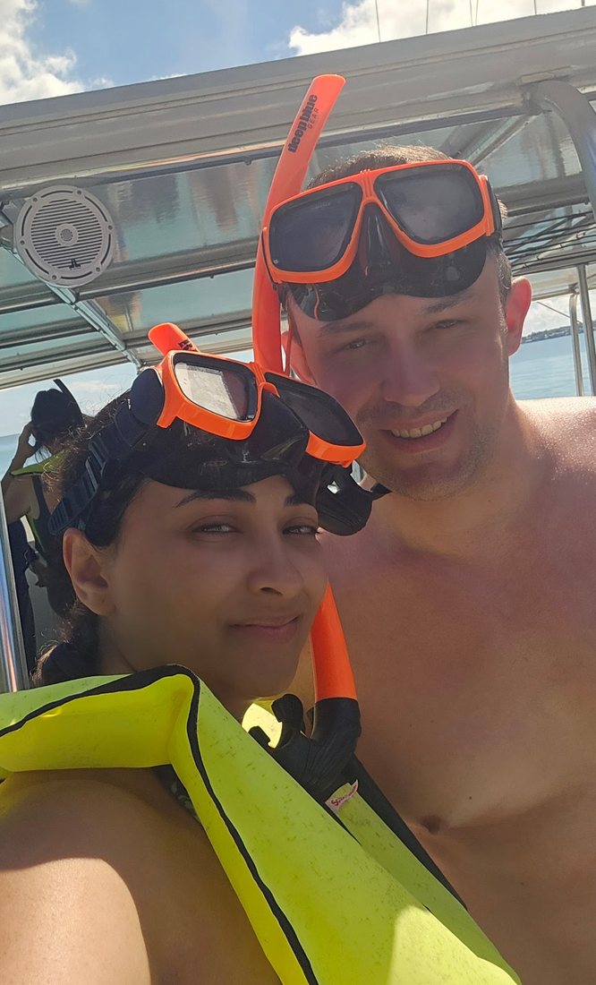 Nick and Nagham in snorkel gear on the catamaran