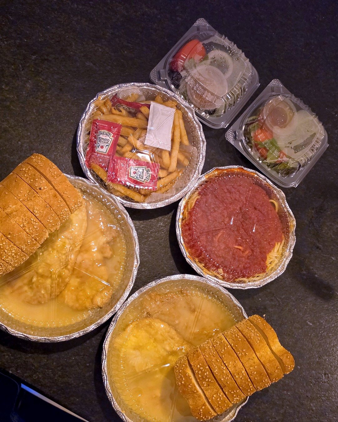 The whole order from above, still sealed, with two loaves of sesame bread
