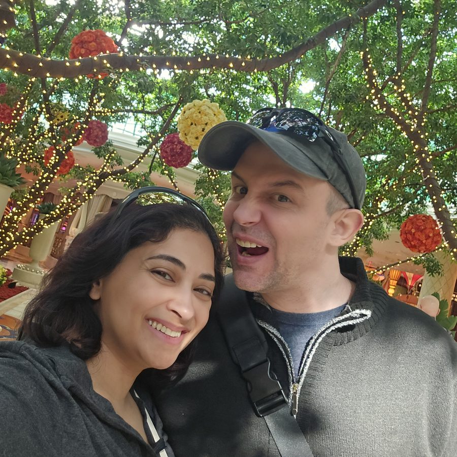 Nick and Nagham under flowers and lights in Las Vegas